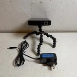 Brookstone 890574 Black Ultra-compact Dlp Pocket Projector With Tripod & Adapter. Fixed Price $59.99.