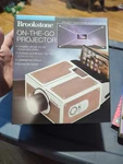 Brookstone On-the-go Projector For Use With Both Ios Android Smart Phones. Fixed Price $30.00.