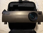 Luxeon X2 Plus Digital Zoom Projector With Case. Fixed Price $88.95.