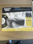 Sharper Image Portable Entertainment Projector, Display's Up 100. Fixed Price $30.00.